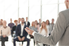 a speaker giving a lecture at a business seminar.