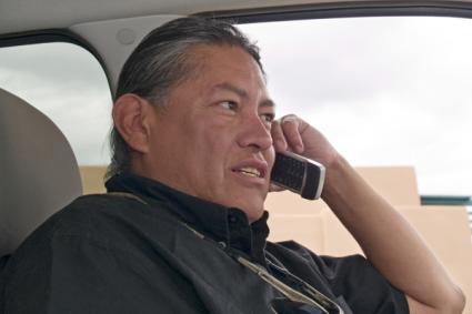 A man talking on a cellphone in a car