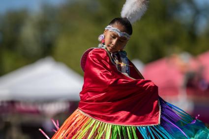 A girl dancing Native American style