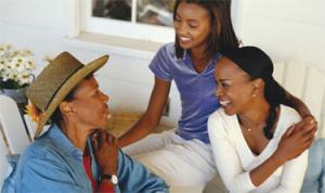 Photo of mother speaking to two teenage daughters